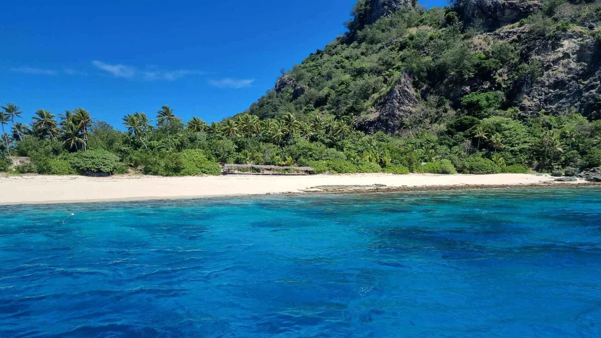 The beach and jungle slope of Monuriki, the Cast Away island reached on the full-day Mamanuca Islands cruise from Port Denarau