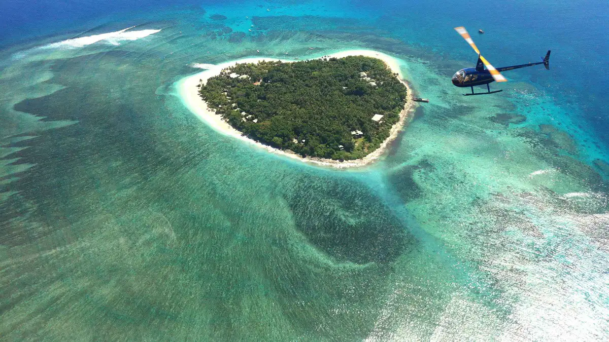 Helicopter view of turquoise reefs and small islands on a scenic Mamanuca Islands tour by air from Nadi, Fiji